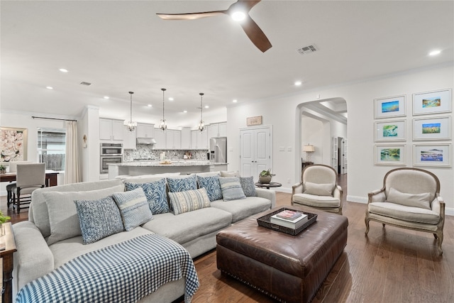 living room with ceiling fan, crown molding, and wood-type flooring