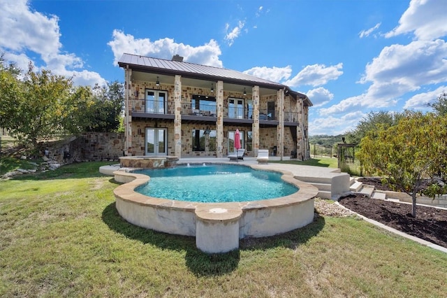 4408 Blacksmith Cv, Spicewood, TX 78669 - back of house featuring french doors, a yard, a balcony, a standing seam roof, and a patio area
