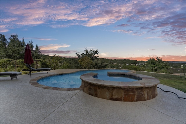 view of pool with a patio and a pool with connected hot tub