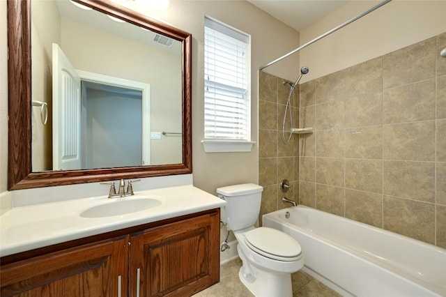 full bathroom featuring tile patterned flooring, vanity, tiled shower / bath combo, and toilet