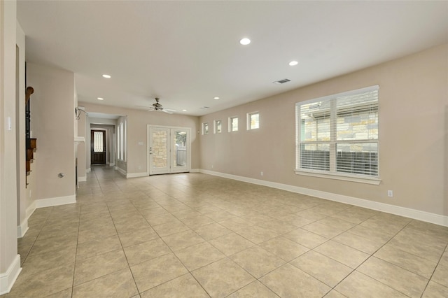 tiled spare room featuring ceiling fan