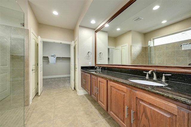 bathroom featuring tile patterned floors, vanity, and tiled shower