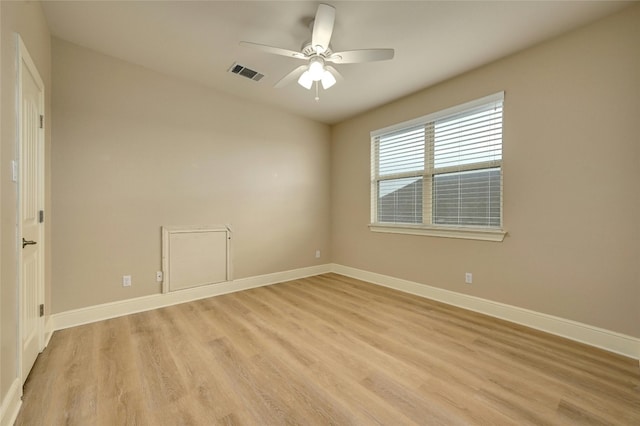 empty room with ceiling fan and light hardwood / wood-style flooring