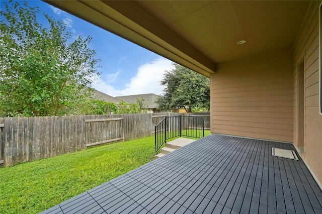 wooden terrace with a lawn