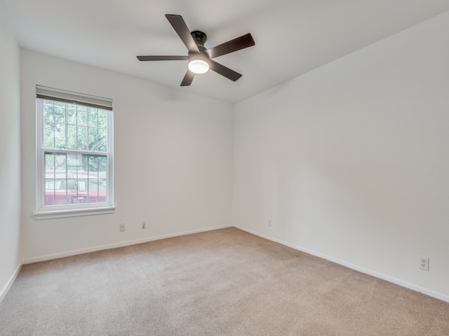 spare room featuring ceiling fan and light colored carpet