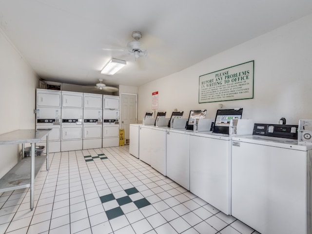 clothes washing area featuring ceiling fan, stacked washer and clothes dryer, light tile patterned floors, and washing machine and dryer