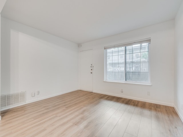 spare room featuring light hardwood / wood-style flooring