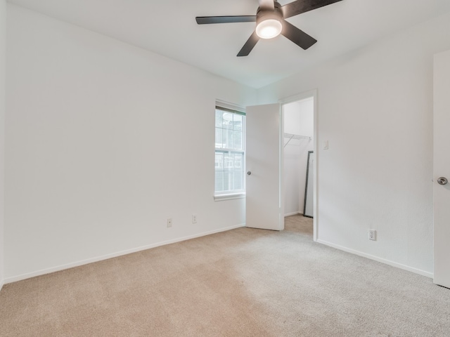 unfurnished room with ceiling fan and light colored carpet