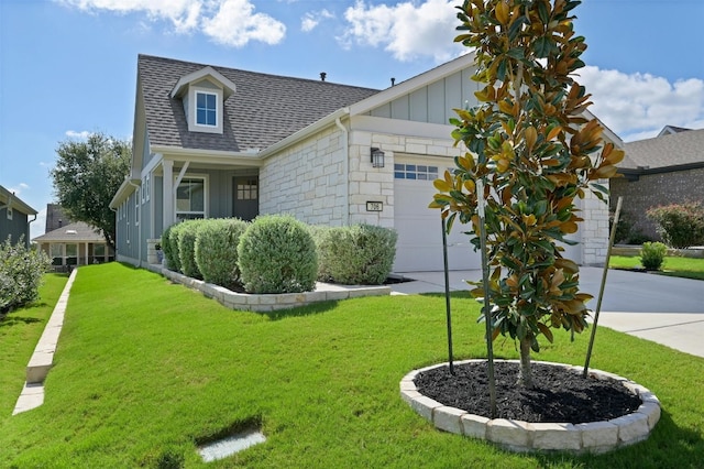 view of front of property with a front yard and a garage