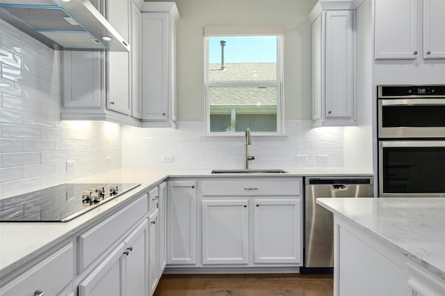 kitchen featuring stainless steel appliances, white cabinetry, and sink