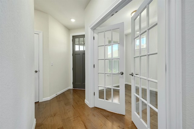 entryway featuring wood-type flooring and french doors