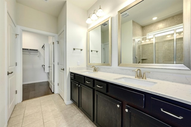 bathroom with vanity, tile patterned floors, and a shower with door