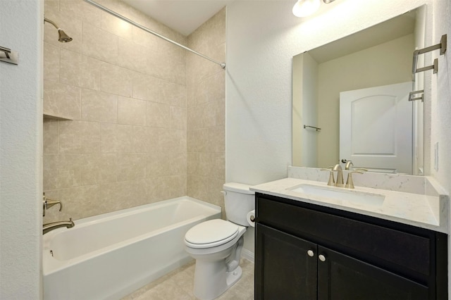 full bathroom featuring tiled shower / bath, vanity, toilet, and tile patterned floors