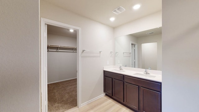 bathroom with vanity and hardwood / wood-style floors