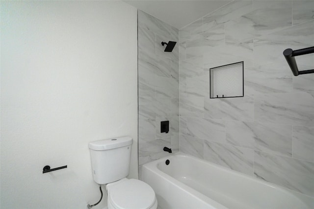 bathroom featuring toilet and tiled shower / bath