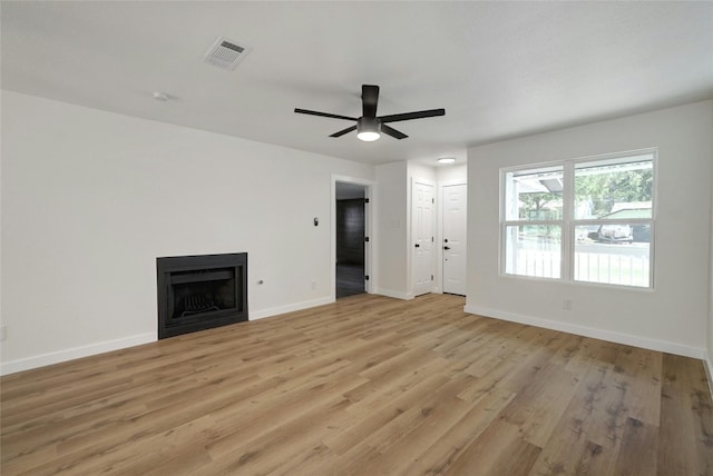 unfurnished living room with ceiling fan and light hardwood / wood-style flooring