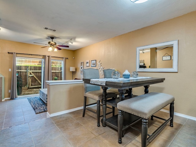 dining area with light tile patterned floors and ceiling fan