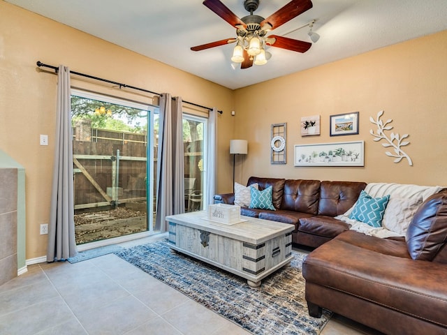 living room with ceiling fan and light tile patterned flooring