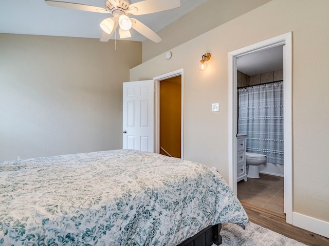 bedroom featuring ceiling fan, ensuite bathroom, and hardwood / wood-style floors