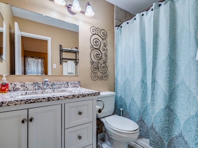 bathroom featuring vanity, toilet, and curtained shower