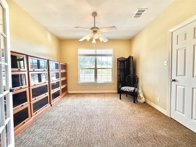 sitting room featuring ceiling fan and carpet