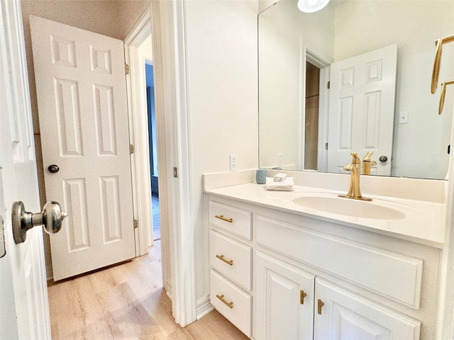 bathroom featuring vanity and hardwood / wood-style flooring