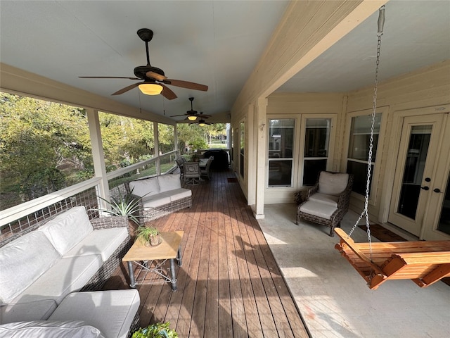 sunroom featuring ceiling fan and french doors