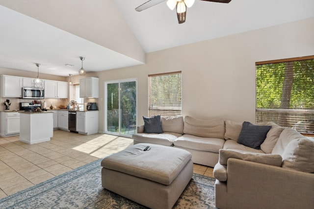 tiled living room featuring ceiling fan and lofted ceiling