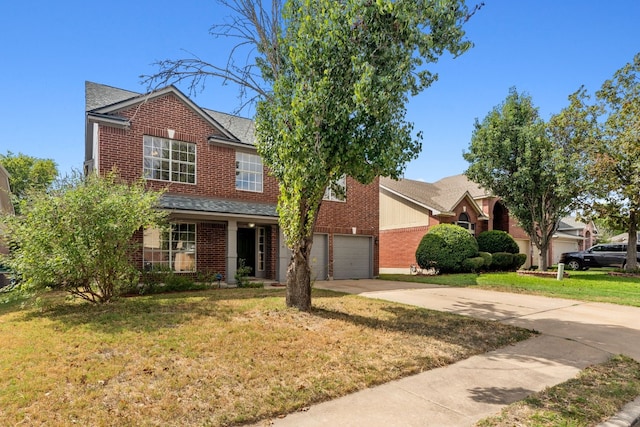 view of front of property featuring a garage and a front lawn