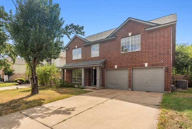 view of front of property with central AC, a front lawn, and a garage