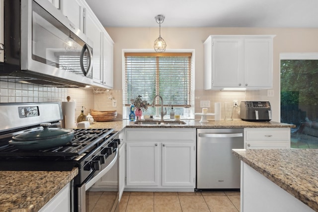 kitchen featuring white cabinetry, sink, appliances with stainless steel finishes, and tasteful backsplash