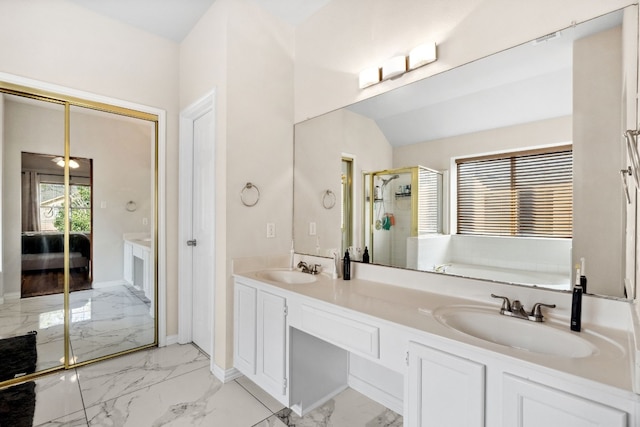 bathroom featuring vanity, vaulted ceiling, and walk in shower