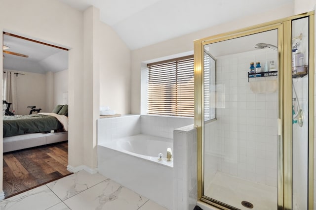 bathroom featuring plus walk in shower, wood-type flooring, and vaulted ceiling