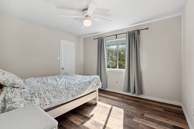 bedroom with dark hardwood / wood-style floors and ceiling fan