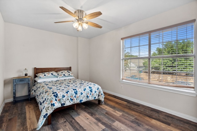 bedroom with ceiling fan and dark wood-type flooring