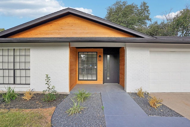 doorway to property featuring a garage and elevator