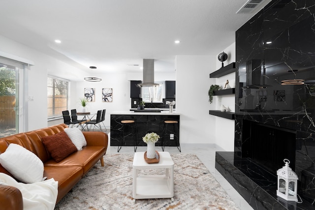 living room featuring a premium fireplace