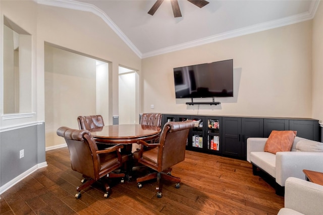 dining room featuring ornamental molding, vaulted ceiling, ceiling fan, and dark wood-type flooring