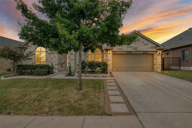 view of front of home featuring a lawn and a garage