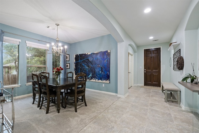 dining area featuring a notable chandelier