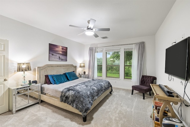 bedroom with ceiling fan and light colored carpet