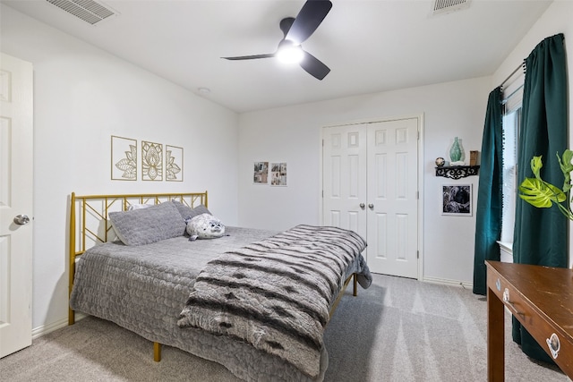 carpeted bedroom with ceiling fan and a closet