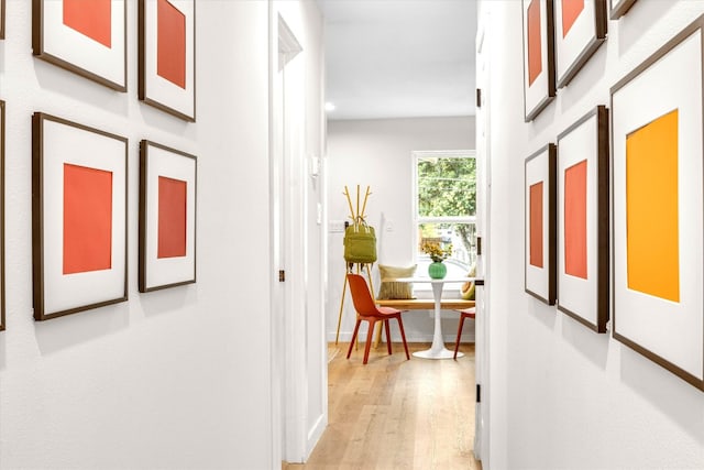 hallway with light hardwood / wood-style floors