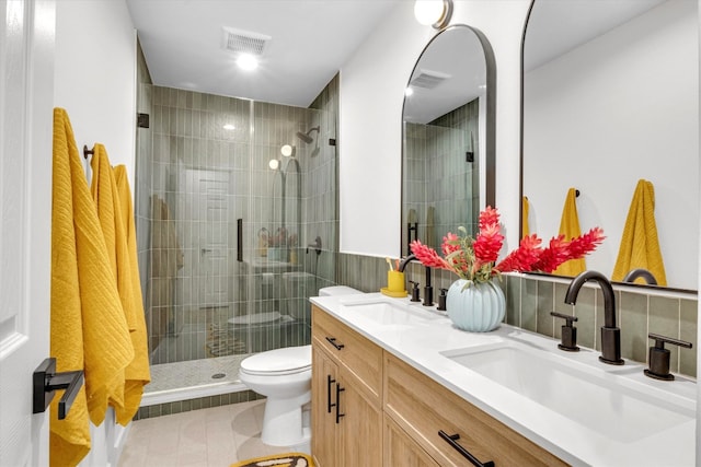 bathroom with vanity, tile patterned flooring, toilet, and walk in shower