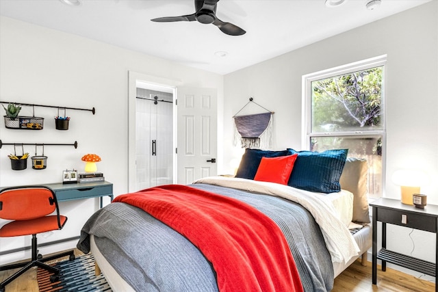 bedroom with ceiling fan, light wood-type flooring, and a baseboard radiator