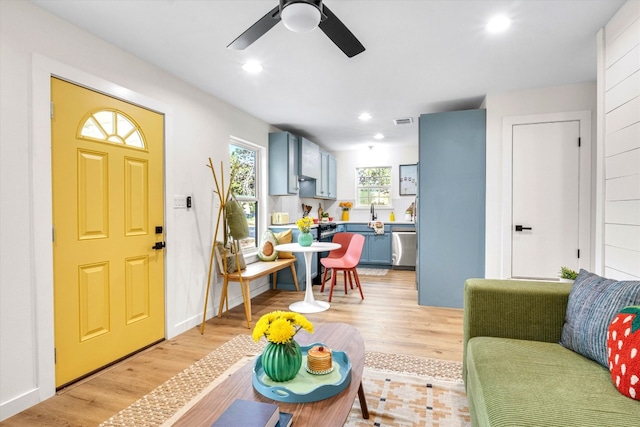 foyer entrance with ceiling fan and light hardwood / wood-style flooring