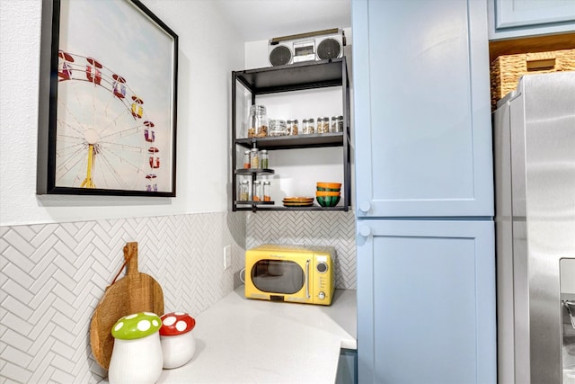 interior space with stainless steel fridge with ice dispenser