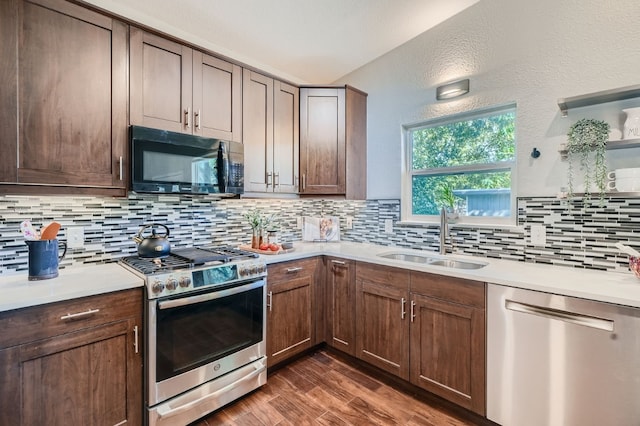 kitchen with dark hardwood / wood-style floors, sink, stainless steel appliances, and tasteful backsplash