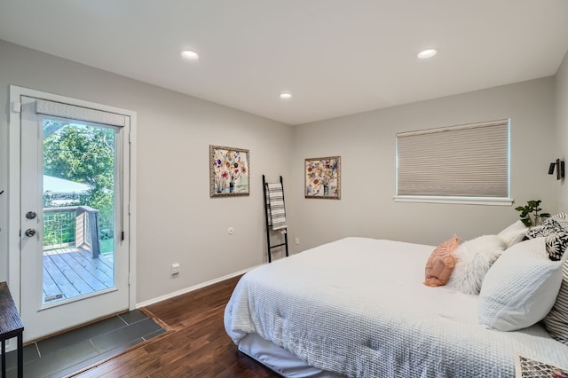 bedroom with access to exterior and dark wood-type flooring