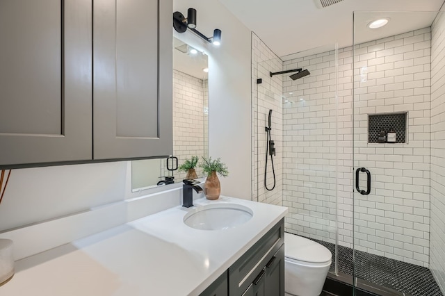 bathroom featuring walk in shower, vanity, and toilet